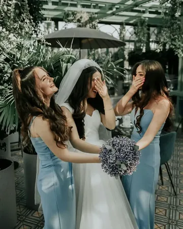 Wedding photo: bride bridesmaids blue dresses garden