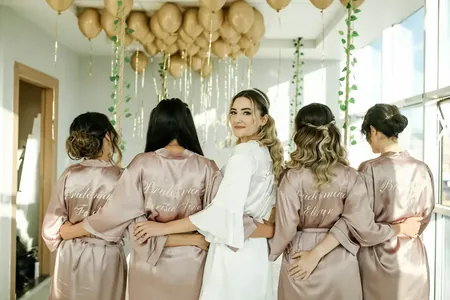 Wedding photo: bride bridesmaids personalized robes backs