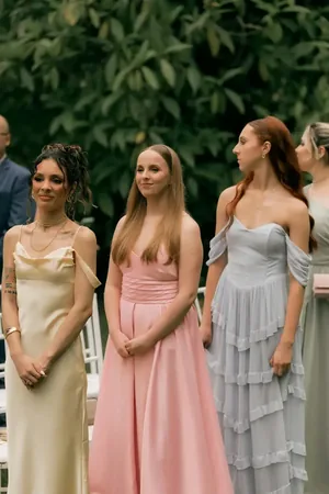 Wedding photo: bridesmaids pastel gowns ceremony