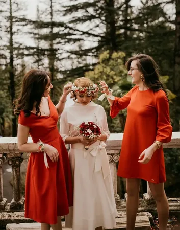 Wedding photo: bridesmaids placing flower crown bride