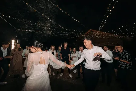 Wedding photo: couple dancing night fairy lights