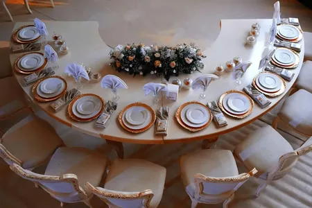 Wedding photo: elegant reception table overhead orange plates